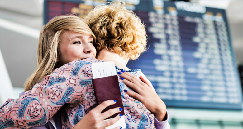 Mother and daughter hugging at the airport