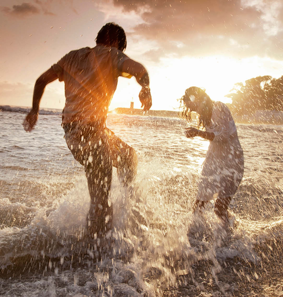 Couple splashing at the beach