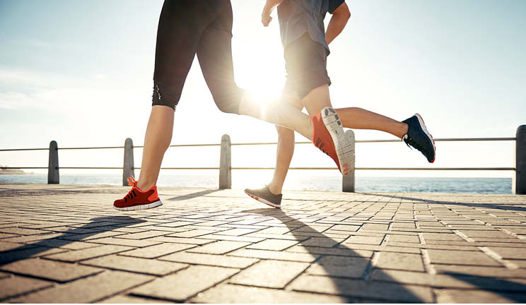 Joggers along water