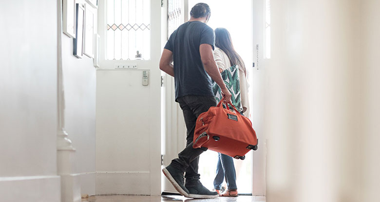 Couple leaving home for a holiday