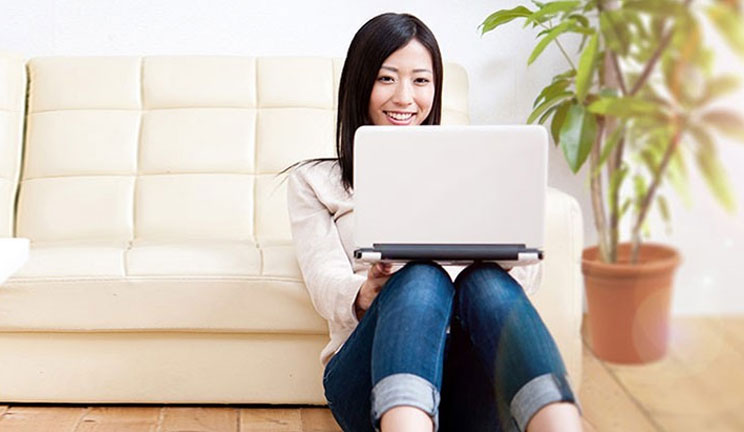 Lady on laptop sitting on floor