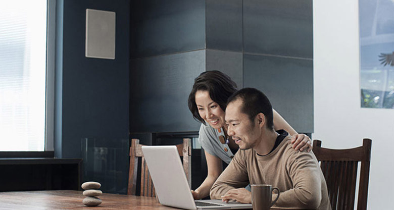 Couple looking at laptop at table