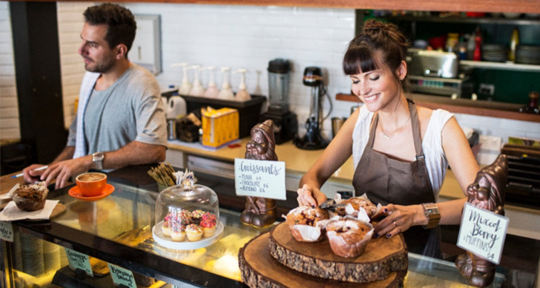 Small business couple in coffee shop