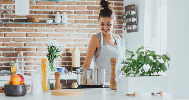 Young woman cooking in kitchen