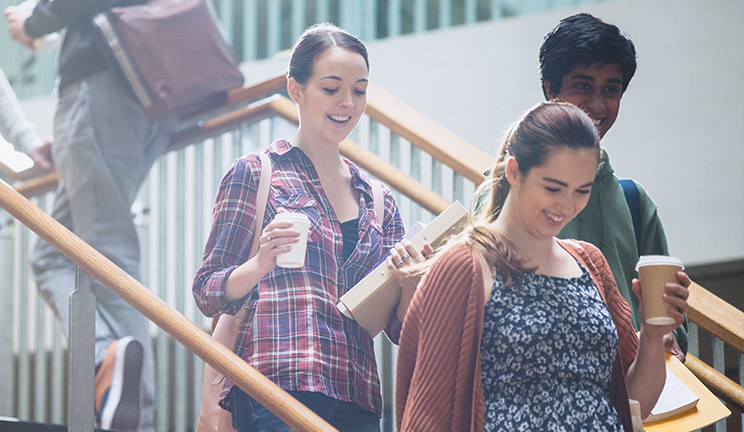 Student on their way, with coffee in hand