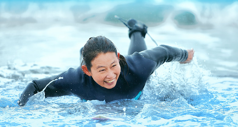 Asian woman surfing in Australia