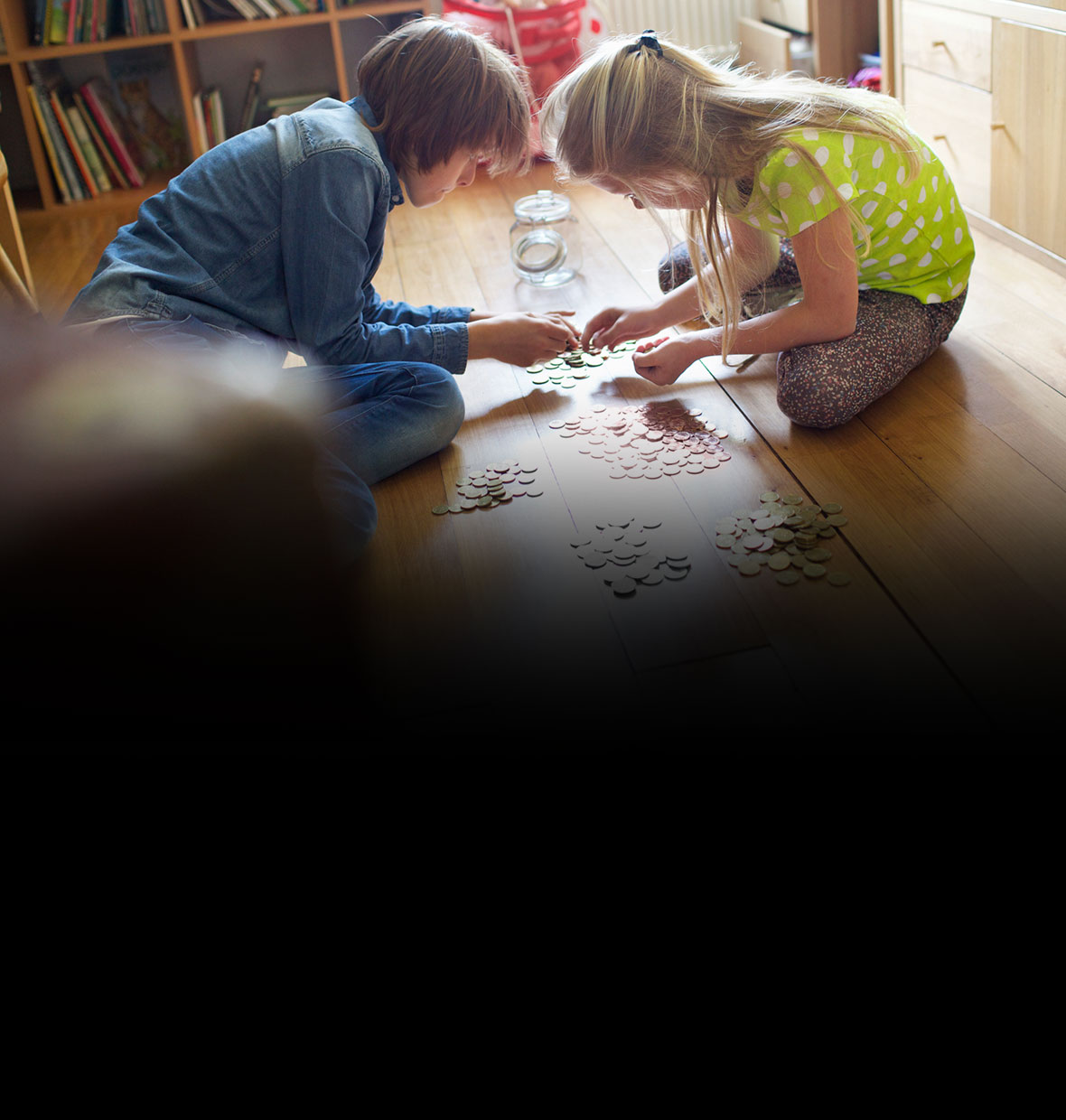 Kids counting their money on the floor