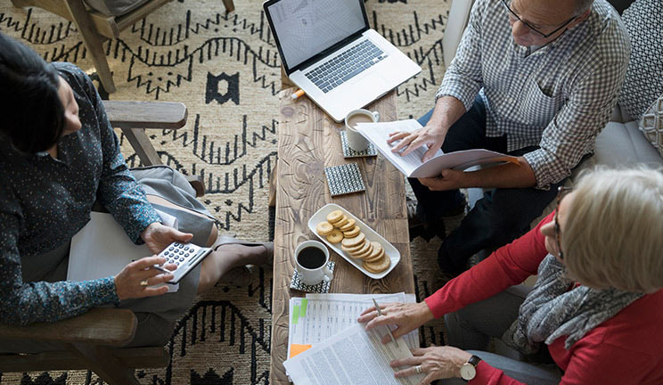 People at a table with a laptop