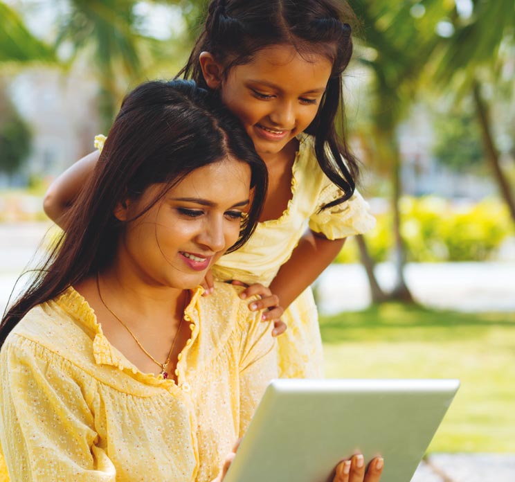 Mother and daughter looking at tablet device