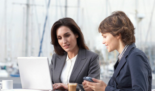Two women looking at laptop