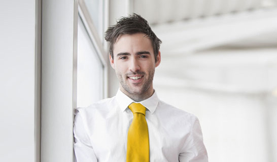 Man in white shirt and yellow tie