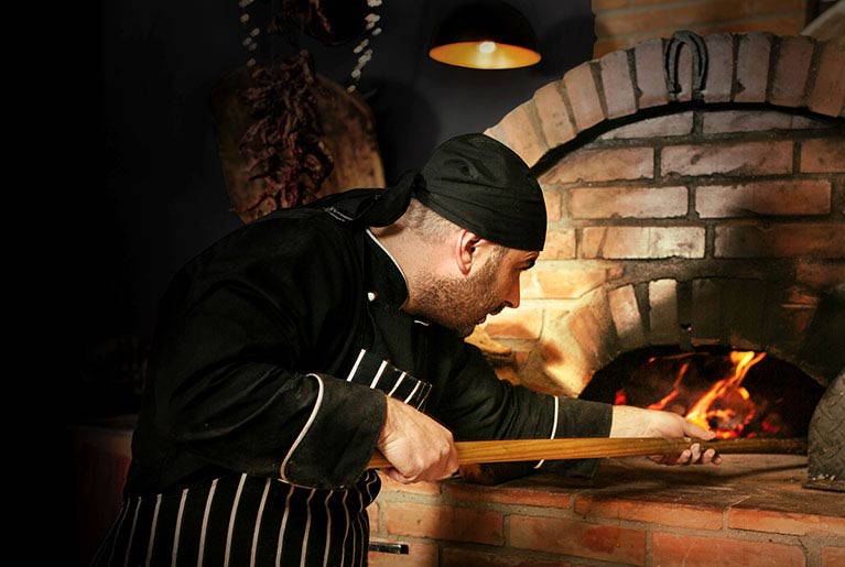 chef and pizza oven
