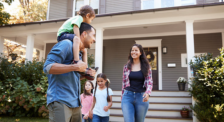 family outside new house