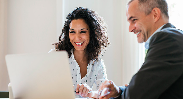 woman and man looking at a laptop