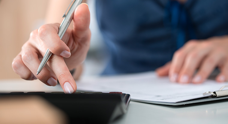 calculator and pen at desk