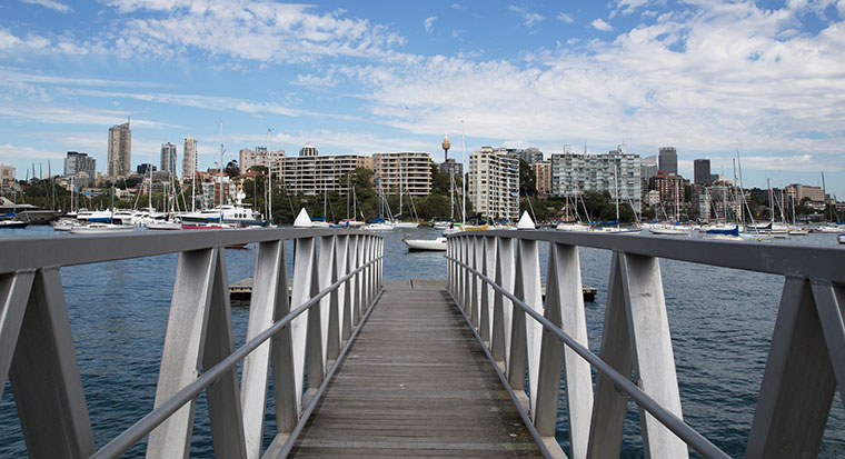 Image of a wharf with buildings in the background