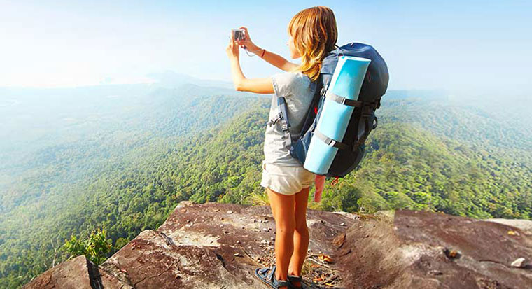 female backpacker travellig with camera