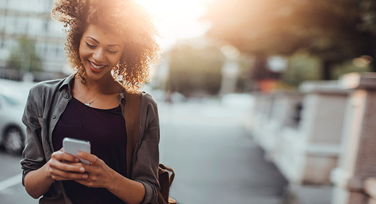 Woman on mobile phone sending money overseas