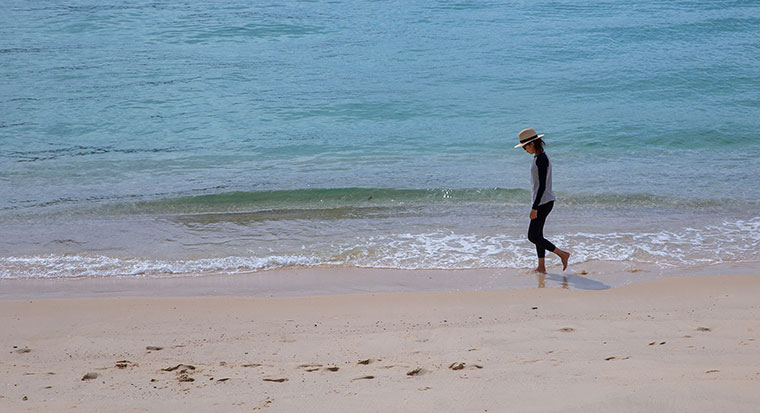 Woman walking along a beach