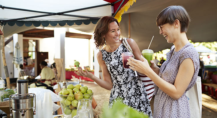 Women at market with juices