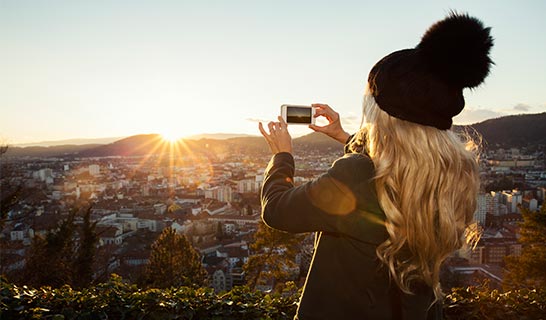 Lady taking photo of a sunset