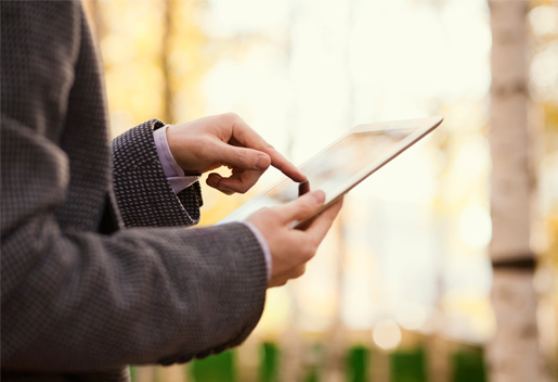 Man on iPad thinking about getting started with investing.