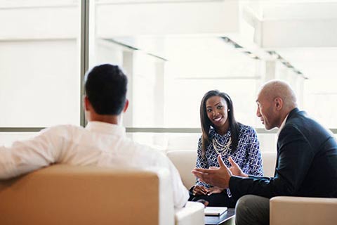 Three employees having a meeting