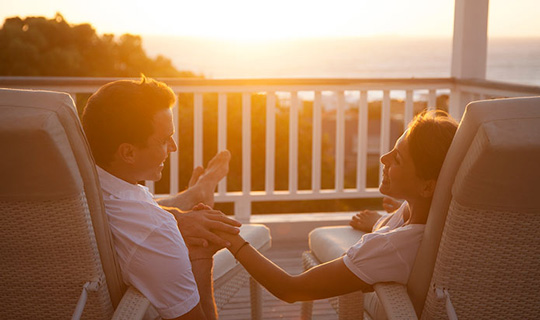 Holiday couple enjoying sunset