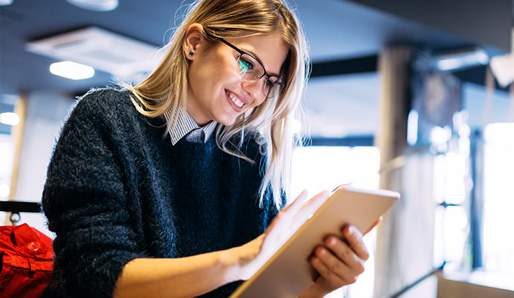 woman on ipad smiling