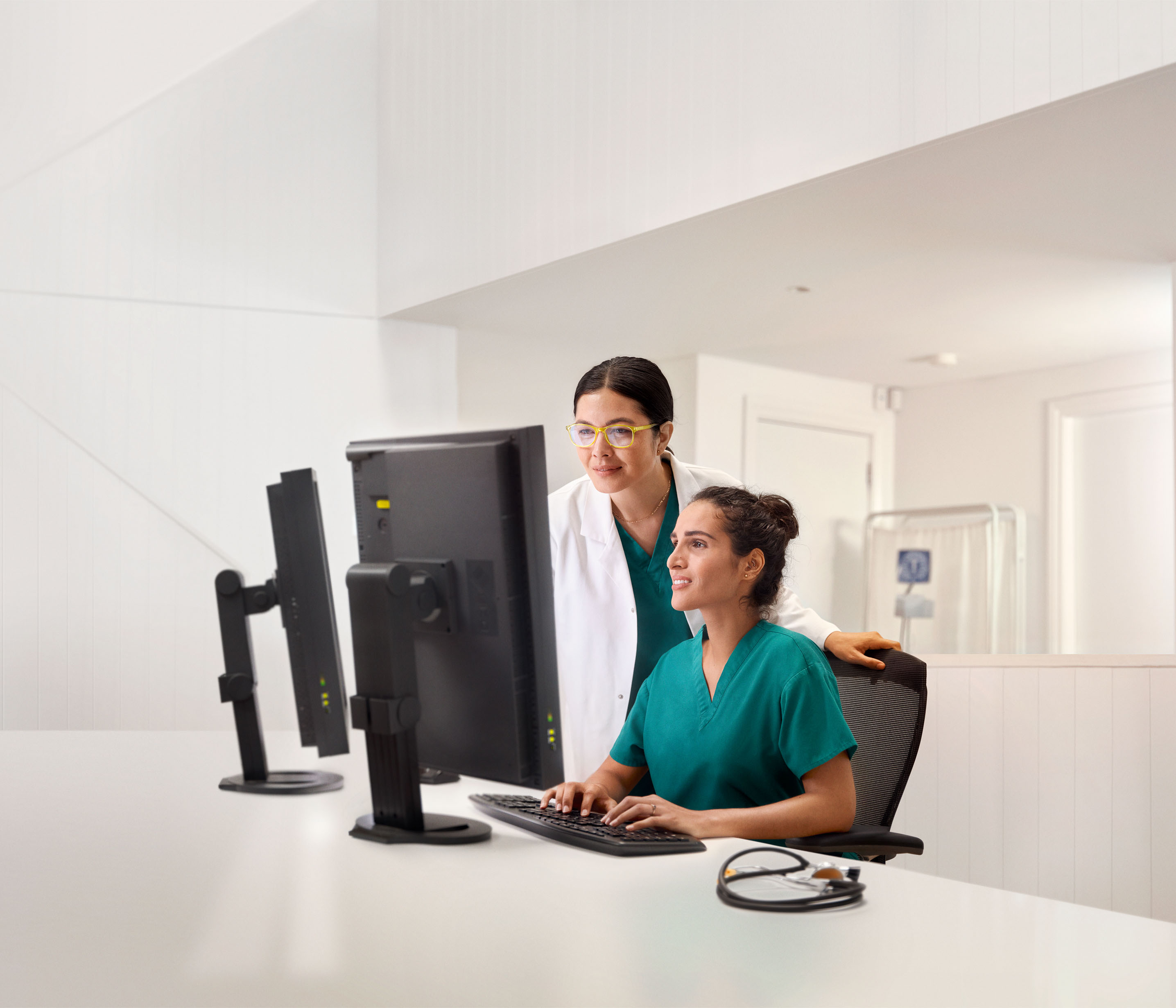 Image of a female doctor sitting in a chair at a desk